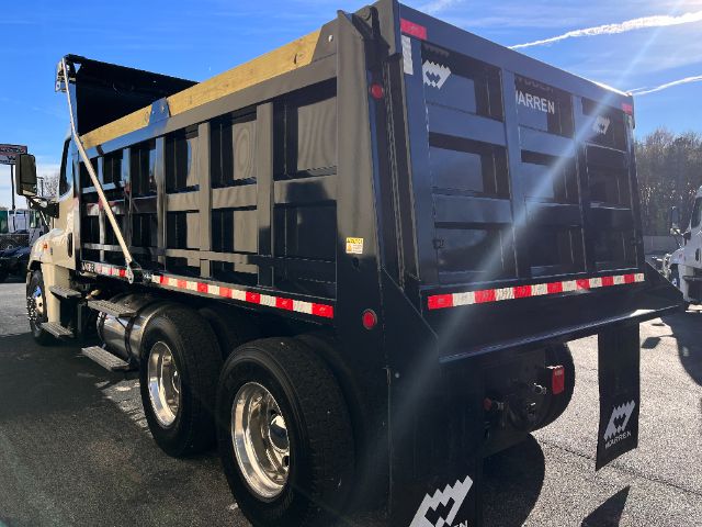 Freightliner Cascadia 125 dump truck with black dump body, side rails, and rear view showing Marren logo on mud flaps and rear chassis.