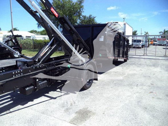Side view of a 2023 Chevrolet Silverado 6500HD truck with a hydraulic lift or dump body, showing the chassis, rear wheels, and cargo bed components.