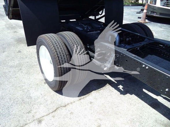 Isuzu NPR HD truck chassis showing dual rear wheels and frame with components.
