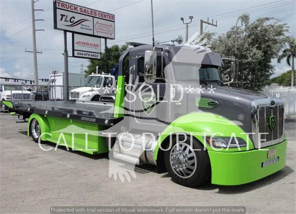 Peterbilt 337 tow truck with lime green accents and gray cab, side view showing flatbed, stock number 2020STEPSIDE, used condition.