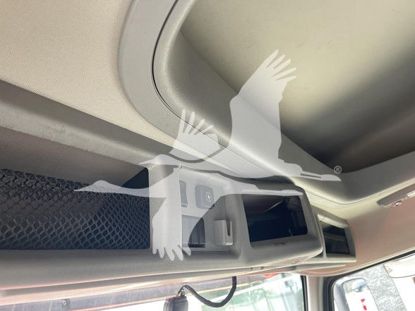 Cab interior showing overhead storage with small cubby and an open compartment. No visible text or labels readable.