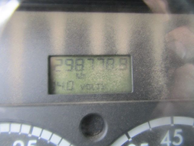 Digital odometer display shows 298,? (inaccurate reading) with a gauge cluster around it. The LCD shows bits of text and numbers, unclear due to glare.