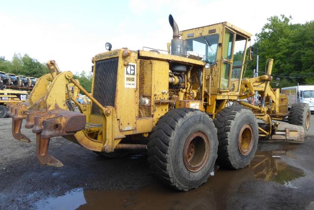 1978 Caterpillar 16G motor grader in yellow with large tires and operator cab, front blade and rear grading attachments visible.