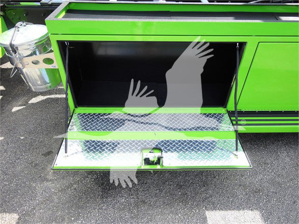 Peterbilt 337 truck side door open showing bright green exterior and diamond plate steps; interior storage space visible with two support arms.