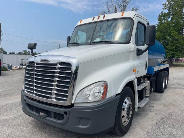 Freightliner Cascadia 2013 septic sewer truck with white cab and blue tank, front grille, and dual rear wheels.