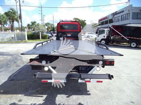 Tow truck flatbed with chain and rear lighting showing back end of 2026 International MV on lot.