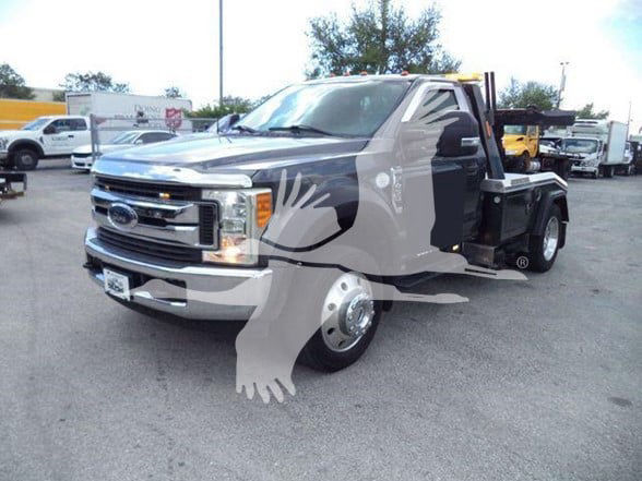 2017 Ford F450 tow truck in a dealership lot with stock number T11463FM. Front grille shows Ford badge; dual headlights; flatbed tow setup visible.