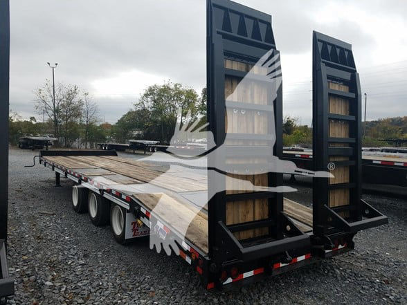 Flatbed trailer with two ramp backs and wooden deck, black metal frames, triple axle visible, no obvious text readable on the trailer itself.
