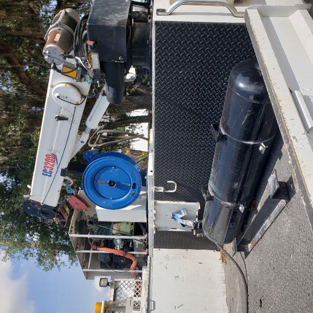 Truck bed with crane; blue hose reel; black cylindrical tank; diamond plate toolbox; EC2000 crane arm visible with red pulley.