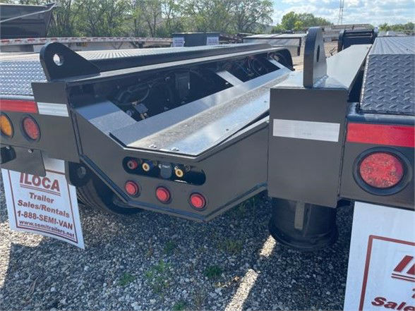 Lowboy trailer rear view showing optional deck at angle with tool storage box and taillights.
