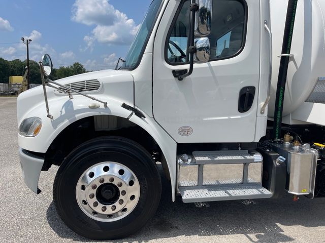 Front passenger side of a 2013 Freightliner M2 sewer rodder truck showing cab step, fuel tank, and front wheel.