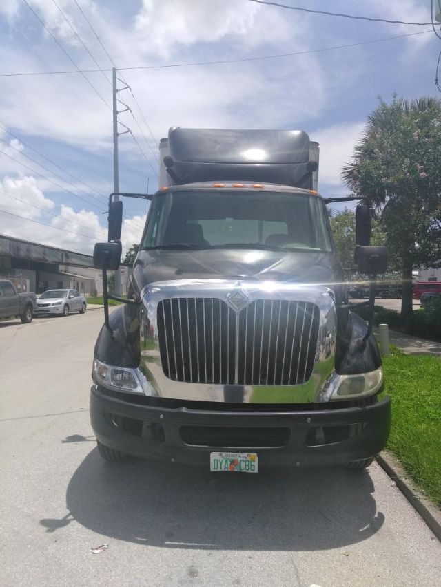 Truck front view showing International grille and chrome bumper with Florida license plate on front bumper.