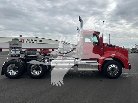 Kenworth T880 conventional daycab truck side view with red cab and chrome exhaust stack, 6x4 configuration, in a dealership lot.