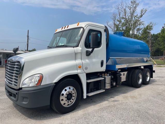 2013 Freightliner Cascadia sewer rodder truck with white cab and blue tank, side view.