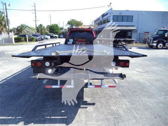 Ram 5500 tow truck bed rear view with platform and lights.
