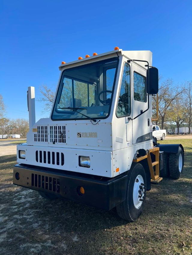 Front-left view of a white 2012 Ottawa 4x2 CNG yard truck with black lower bumper, orange marker lights on cab roof, and dual rear wheels.