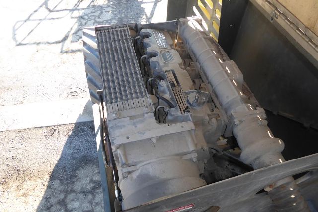 Grove T60 engine bay and hydraulic components visible in the boom lift base area.