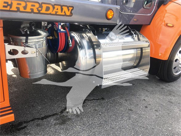 Peterbilt 337 side view showing polished chrome fuel tank, cylindrical air filter housing, and chrome steps beneath orange body panel.