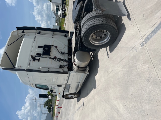 2016 Freightliner Cascadia sleeper cab truck rear/side view with tractor fuel tank and fifth wheel visible.