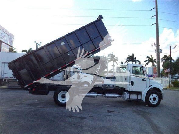 Dump truck with raised cargo bed on a Freightliner Business Class M2 106 chassis.