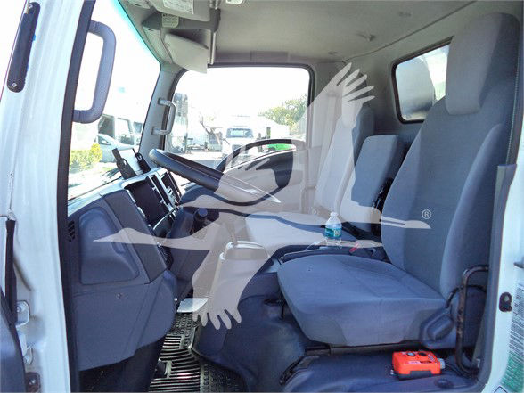 Isuzu NRR truck interior showing driver and passenger seats with steering wheel and dashboard.