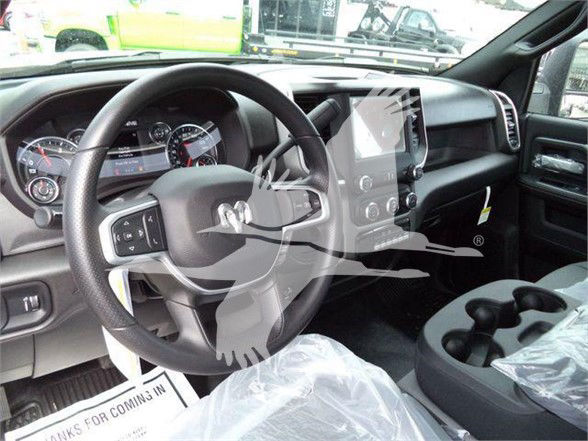 Ram 4500 interior showing steering wheel, large touchscreen display, and center console with cup holders.