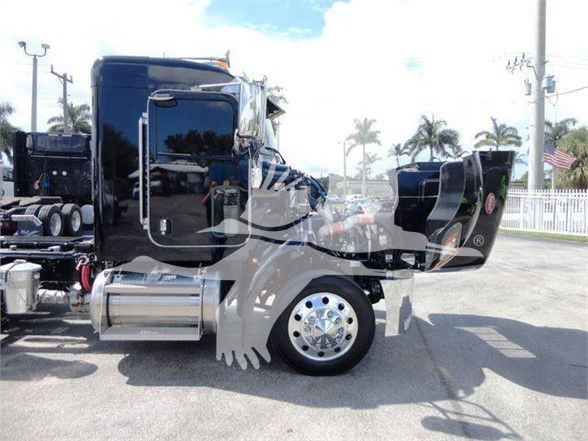 Peterbilt 337 truck cab and chassis side view with polished wheel and black cab, no trailer.