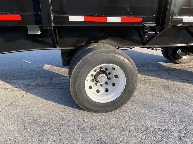 Truck trailer wheel and undercarriage with a single rear dual wheel visible; no readable labels or markings.