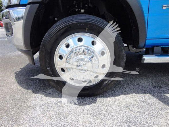 Ram 4500 wheel and tire close-up showing chrome hubcap and tire on blue truck fender.