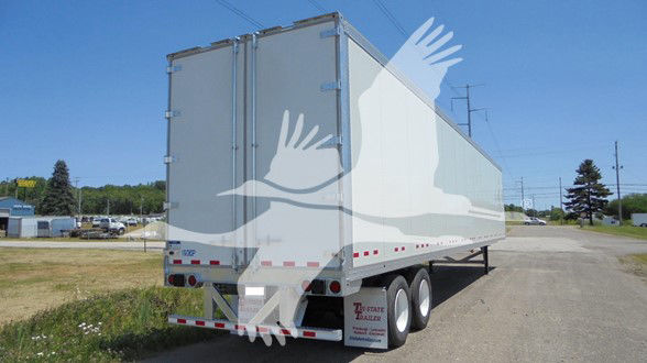 Rear and side view of a Vanguard VXP trailer with double doors, triple axle, white exterior, in-service condition.