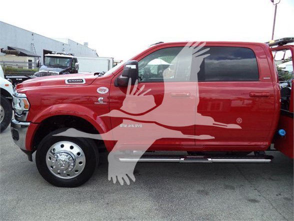 Truck side view showing RAM badge and Cummins emblem on red 2024 Ram 5500 Laramie. Visible text includes 'RAM', 'CUMMINS', '3500HD' under door area; chrome wheel covers and side steps visible.