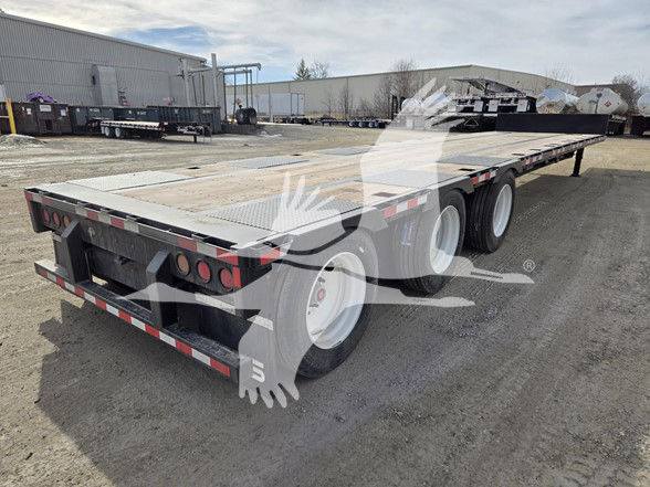 Tri-axle steel drop deck trailer with expandable rear section, three axles, flatbed, rear tail lights, reflective safety tape, and wood decking.