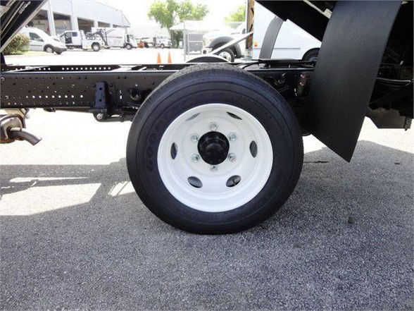Isuzu NPR HD truck wheel and chassis showing white steel wheel and tire in chassis area.