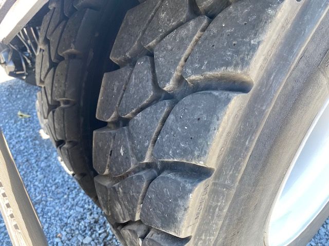 Tire close-up on heavy-duty truck with large tread blocks