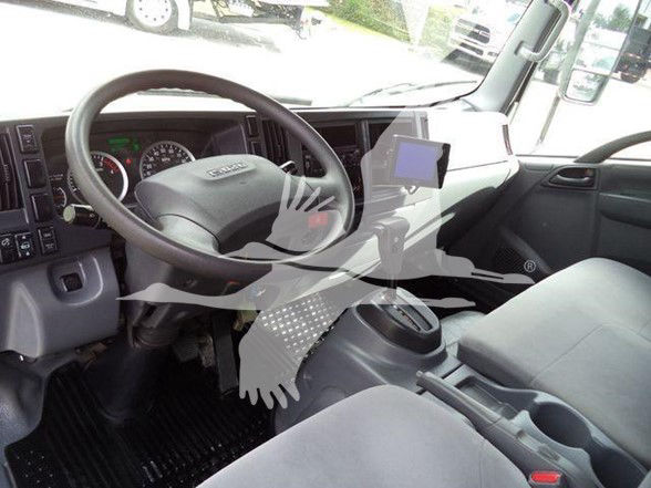 Isuzu NPR HD truck interior showing steering wheel, dashboard, and center console. Visible text includes 'Isuzu' on steering wheel and gauges on instrument cluster.