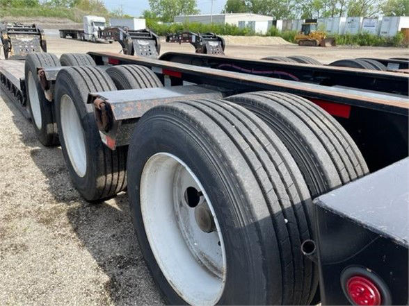 50ft Fontaine 55-ton tri-axle lowboy trailer showing multiple tandem axles and dual tires.
