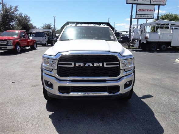 Ram 5500 HD truck front view with black grille and RAM lettering, chrome bumper, daytime lighting, across a dealership lot.