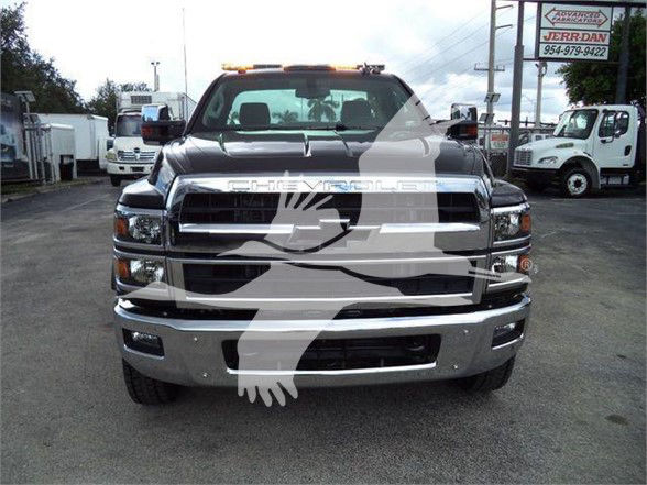 Front view of a 2023 Chevrolet Silverado 6500HD truck with large chrome grille, bumper, and dual headlights. Overlay watermark obscures center. Visible text on the front grille reads CHEVROLET.