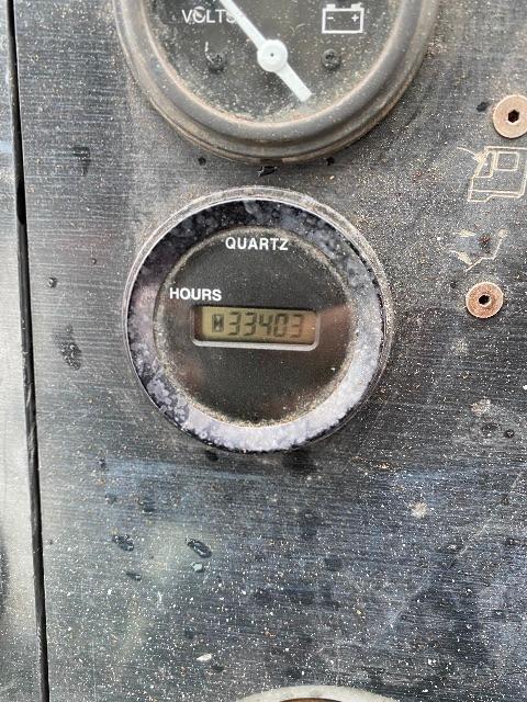 Quarts/hour gauge display shows "FOUR HOURS"? Wait the meter reads '0' and 'HOURS' label. Circular gauge with digital display reading 'COFRE?'. Hard to decipher. Next to it a gauge labeled 'VOLT' with pointer. Dirt and wear around.