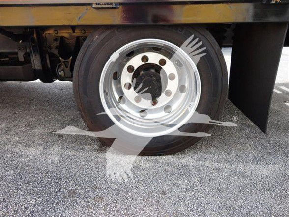Chevrolet Silverado 6500HD truck wheel with chrome hub and flatbed underside visible.
