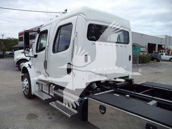 Freightliner Business Class M2 106 cab with side steps and rear chassis, white exterior, tow truck configuration.