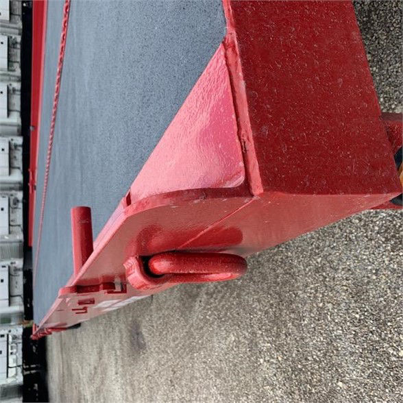 Single axle drop deck container delivery trailer with red-painted rear end and loading hook, side hook components visible.