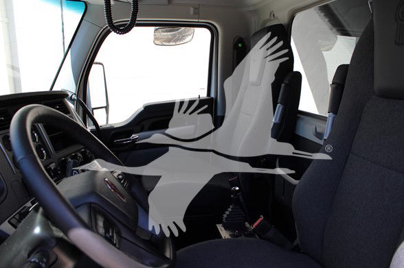 Kenworth T880 truck interior cabin view with steering wheel and driver seat. Window and dashboard visible.