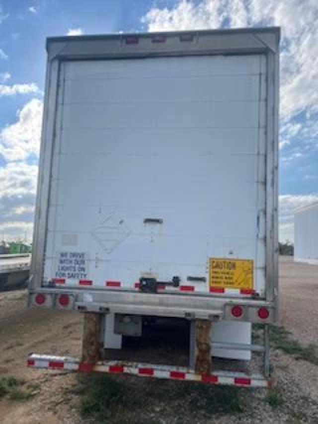 Trailer rear view showing a white Great Dane dry van trailer with rear doors and bumper guards.