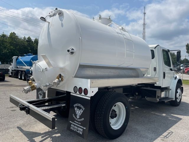 White 2015 Freightliner M2 sewer/ septic vacuum truck with cylindrical tank mounted on a medium-duty chassis. rear view shows vacuum hose connectors and bumper.