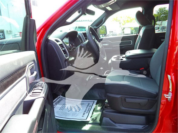 Ram 5500 interior showing front seats and dashboard from driver side with red exterior.
