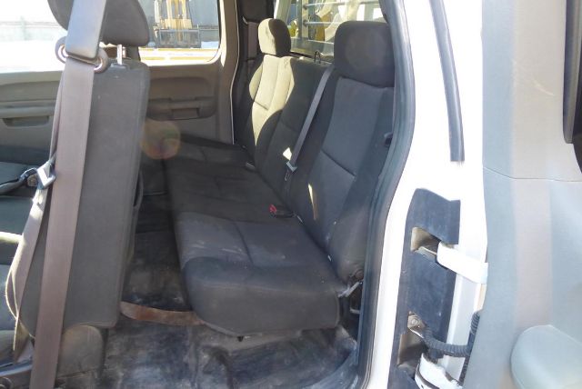 2011 Chevrolet 2500HD interior rear seating and door frame with bench seat and seatbelt, showing fabric seats and truck cargo area.