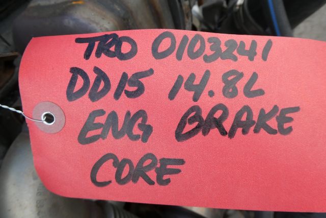 Red tag with handwritten black text: 'TRD 0103241 DD15 14.8L ENG BRAKE CORE' attached to engine area.