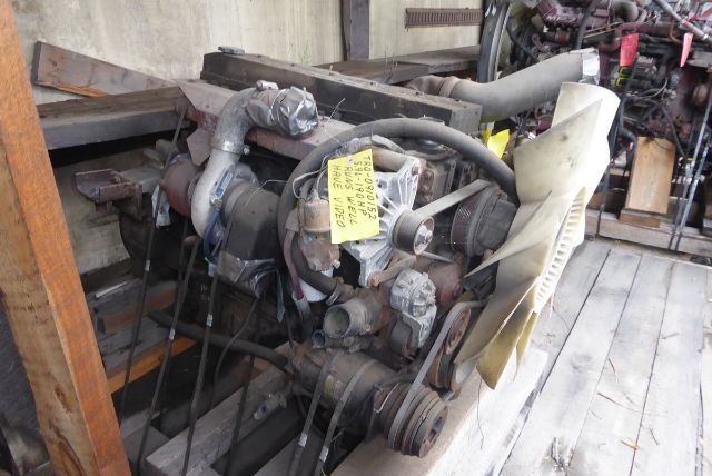 EFISB 5.9L Cummins engine with fan and belts, mounted on a wooden pallet, tag visible on engine