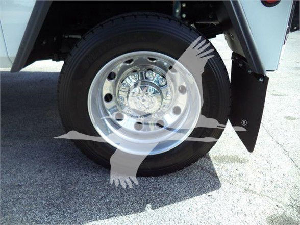 Ram 4500 truck wheel and tire close-up showing chrome hubcap and black tire, with fender and mudflap visible.